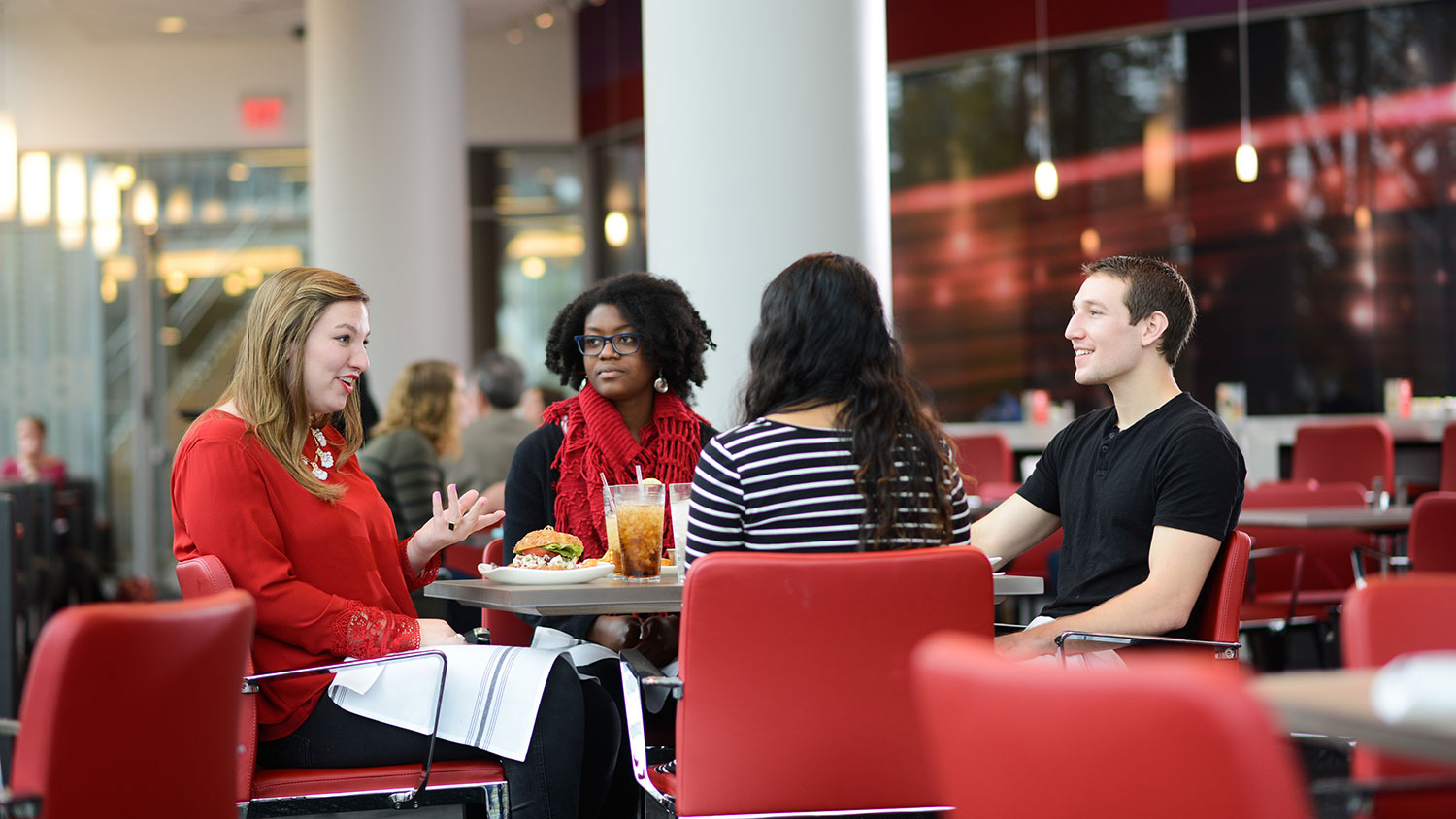 Faculty and staff sitting at a table talking