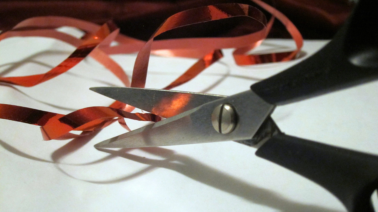 scissors cutting red tape