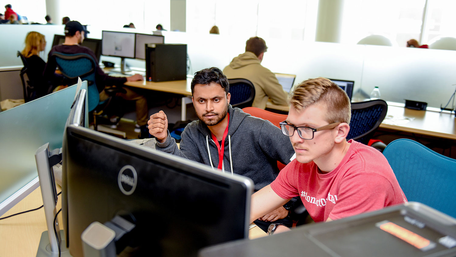 Two male graduate students looking at a computer