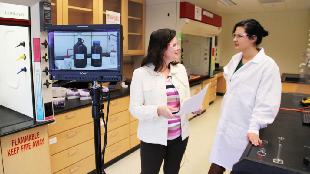 Maria Gallardo-Williams and a student during filming of a video in an organic chemistry lab.