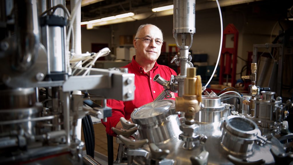 Josip Simunovic in his lab, surrounded by shiny, metal equipment.