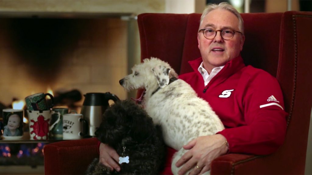 Randy Woodson in easy chair with dogs.