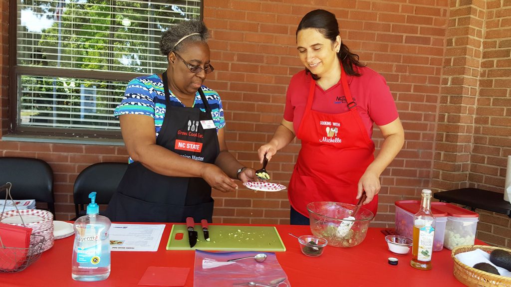 Two women doing a cooking demonstration