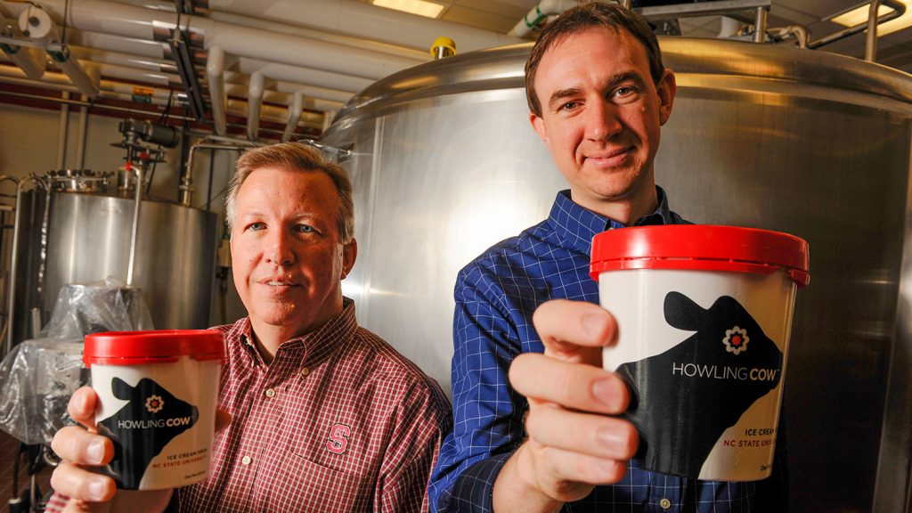 Gary Cartwright and Carl Hollifield holding Howling Cow ice cream pints.