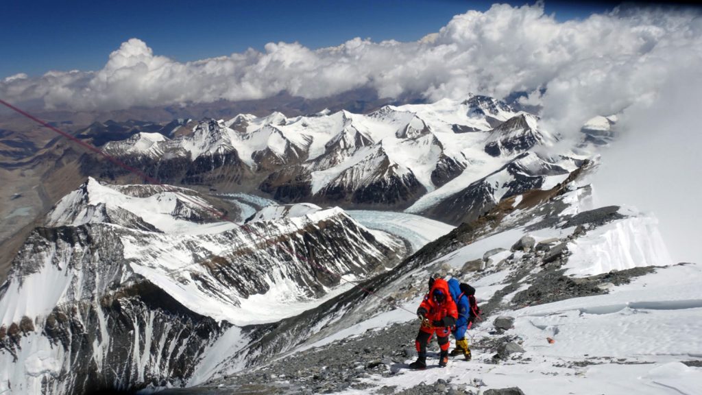 Two climbers on the snowy slopes of Mount Everest.