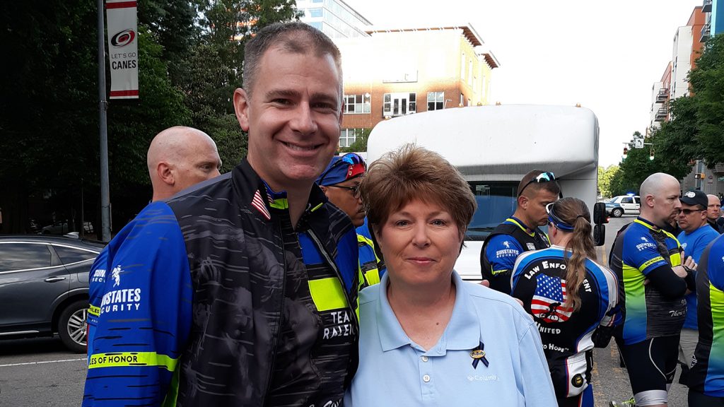 Kendrick is greeted by Christopher Driver's aunt at the finish line in Washington, D.C.