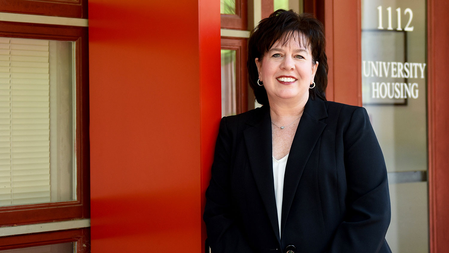 NC State Housing Director Donna McGalliard standing in front of Pullen Hall