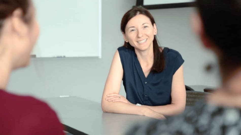 Lorena Bociu sitting at table with students.