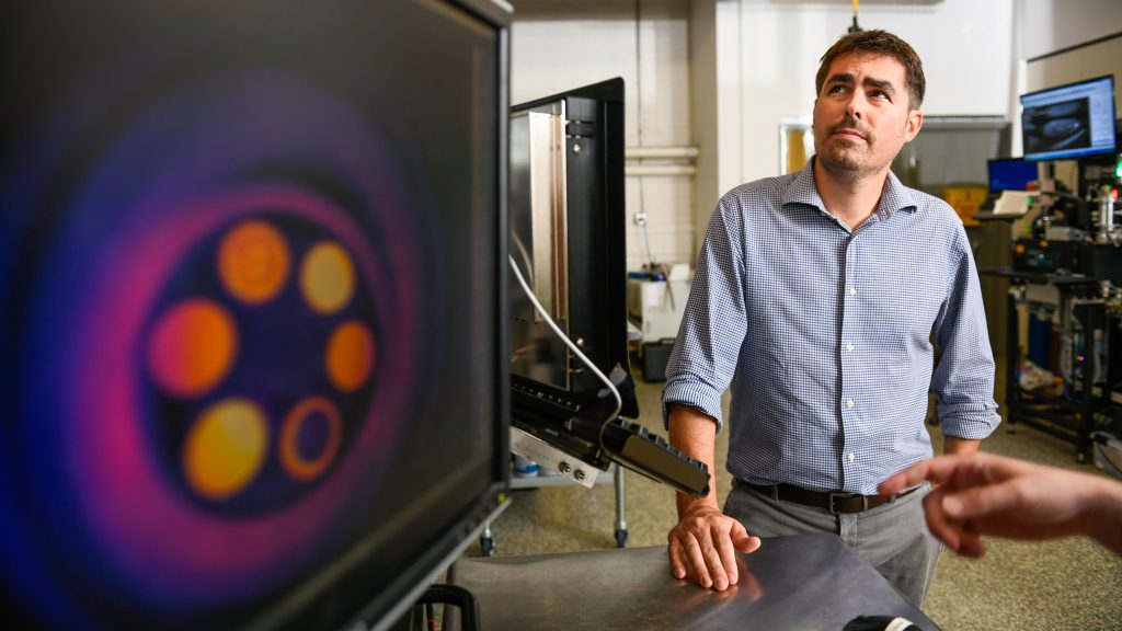 Tim Horn examines a monitor in NC State's 3D printing lab.