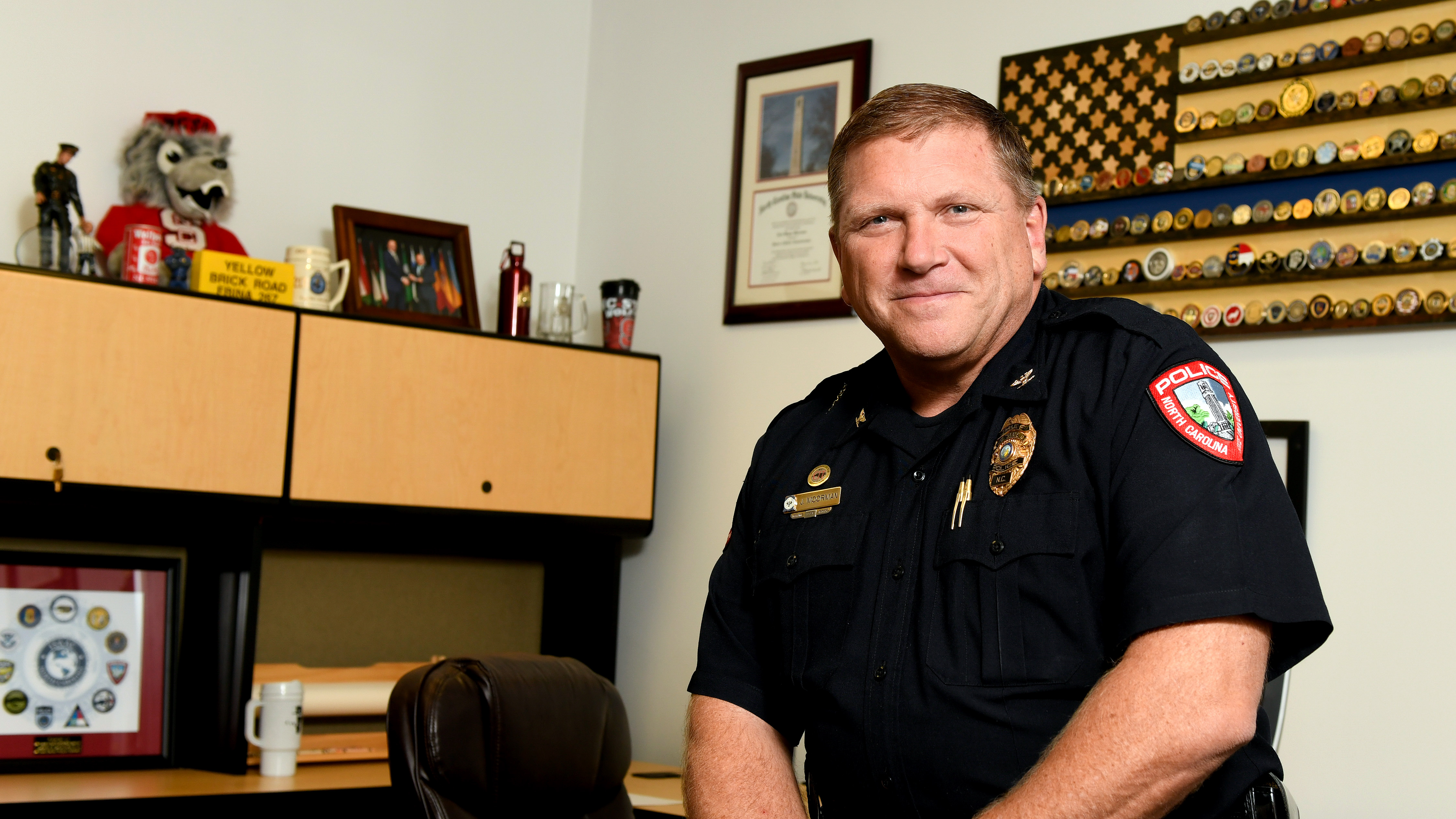 Jack Moorman sits on his desk in his office.