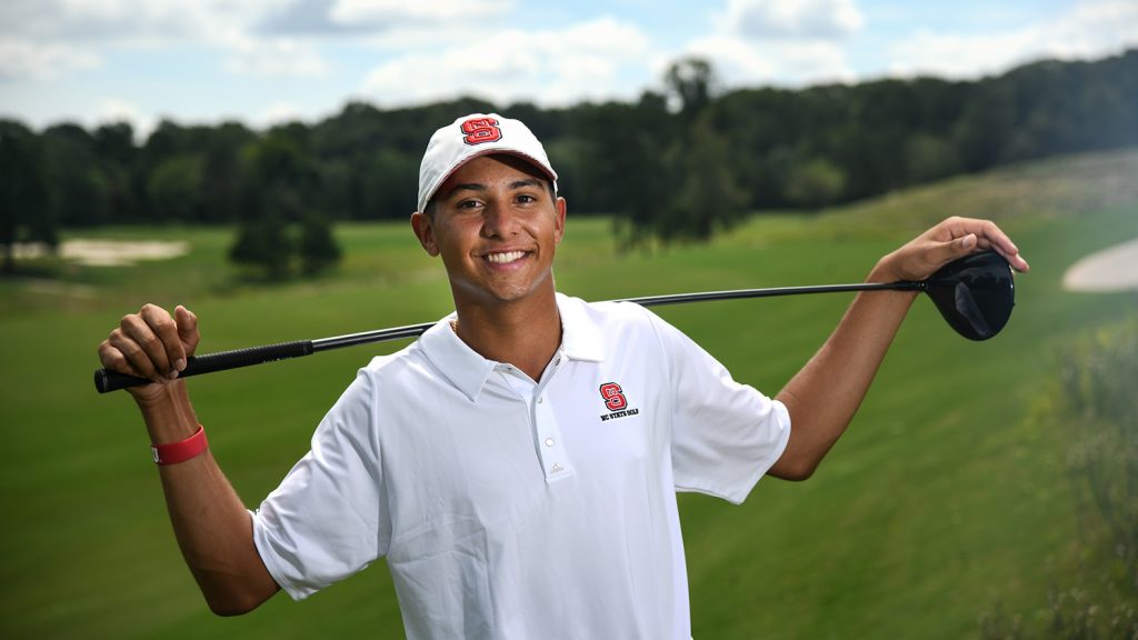 Incoming student Spencer Oxendine stands on the golf course with his club.