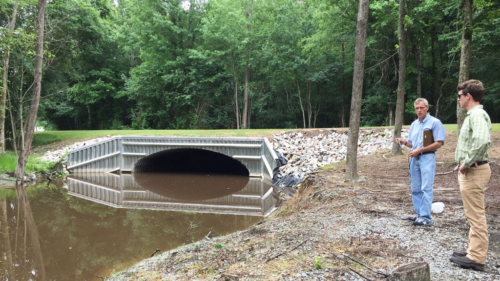 Researchers examine a bridge crossing in Bertie County that was replaced after flooding from Hurricane Matthew breached the road