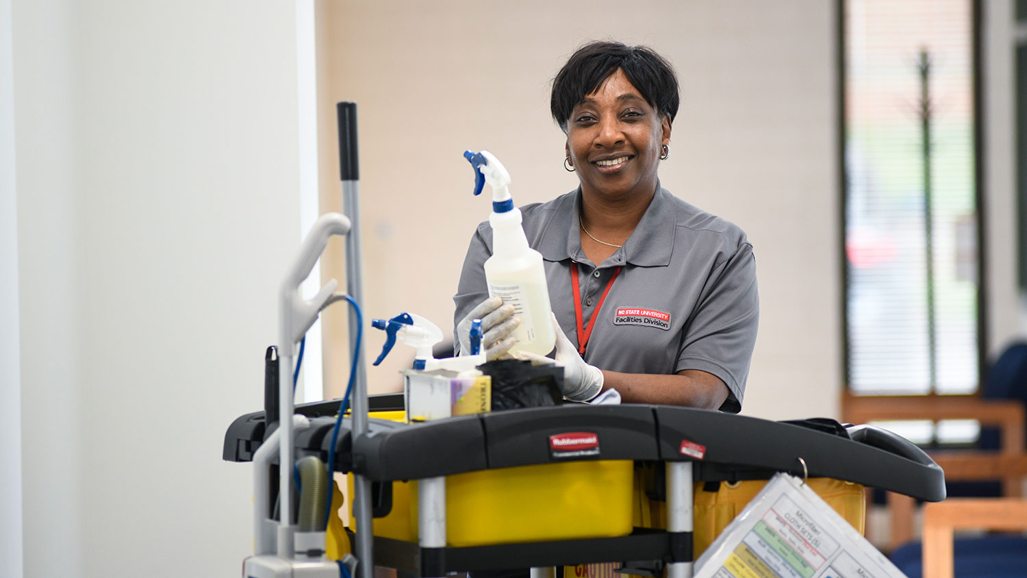 NC State housekeeping employee Benita Womack with cleaning supplies