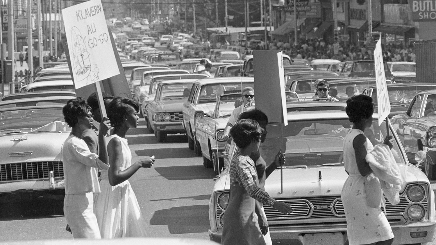 Protesters march during a Ku Klux Klan rally in downtown Raleigh, one of the never-before-published photos that will be on display at the African American Cultural Center Art Gallery next Wednesday. [Photo courtesy of State Archives of North Carolina].