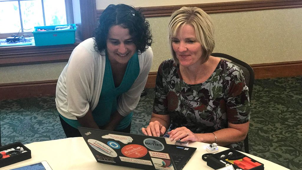 Two women working at a computer