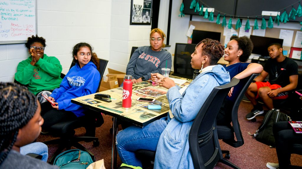 Students discuss the next issue at a Nubian Message staff meeting