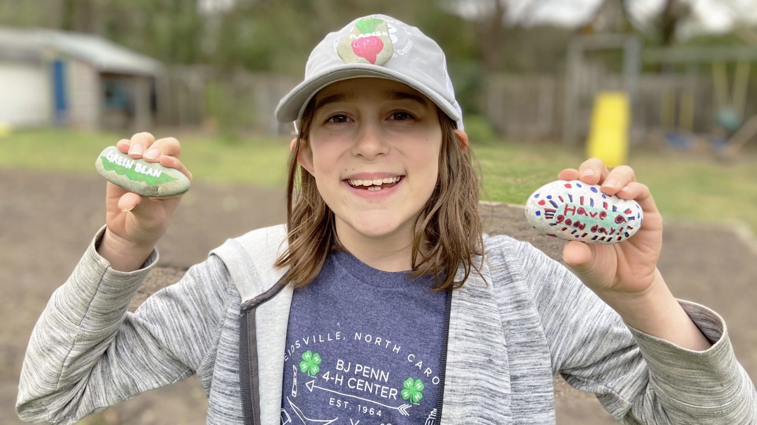 Girl with painted rocks