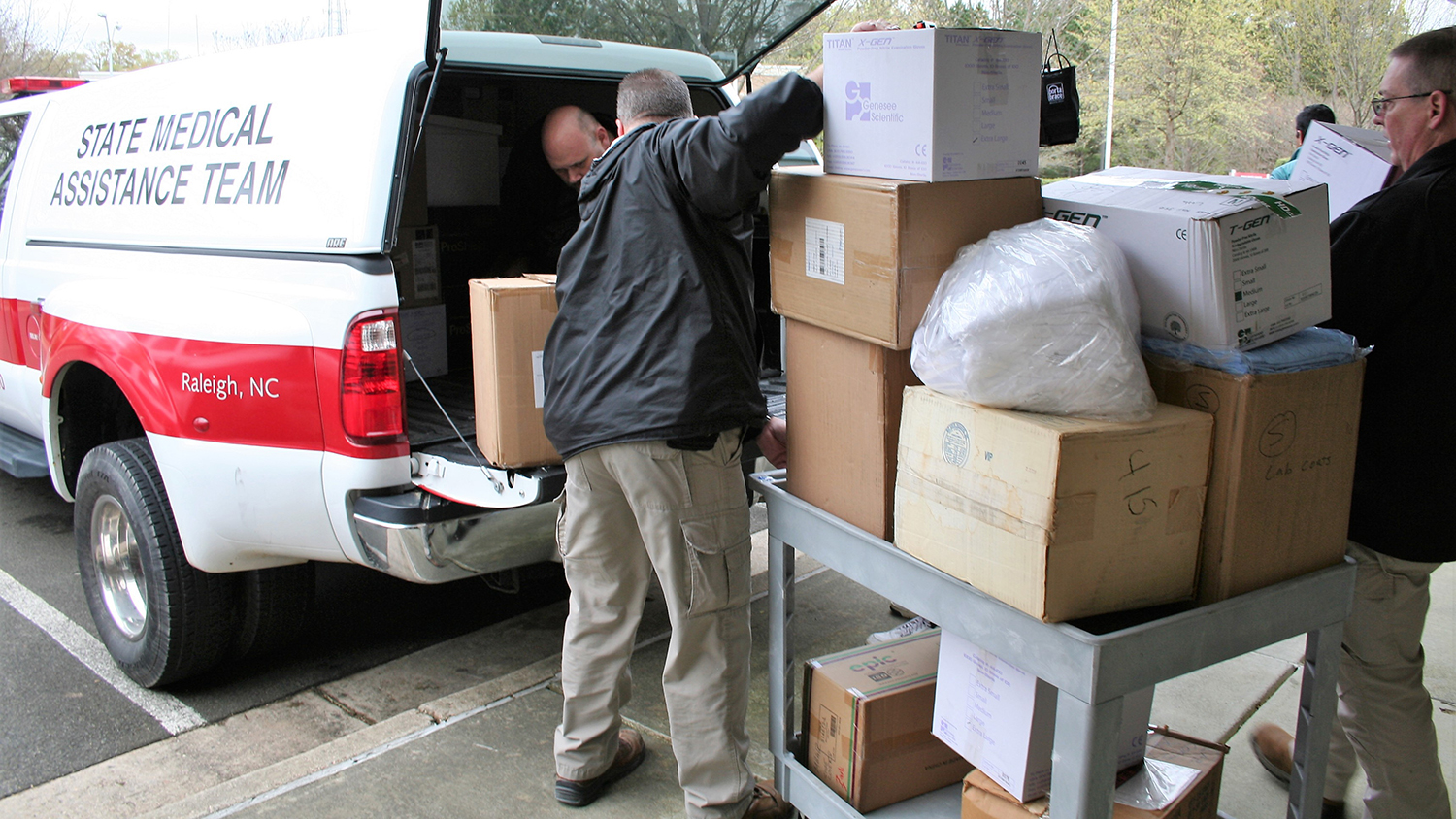 Workers loading supplies into truck.