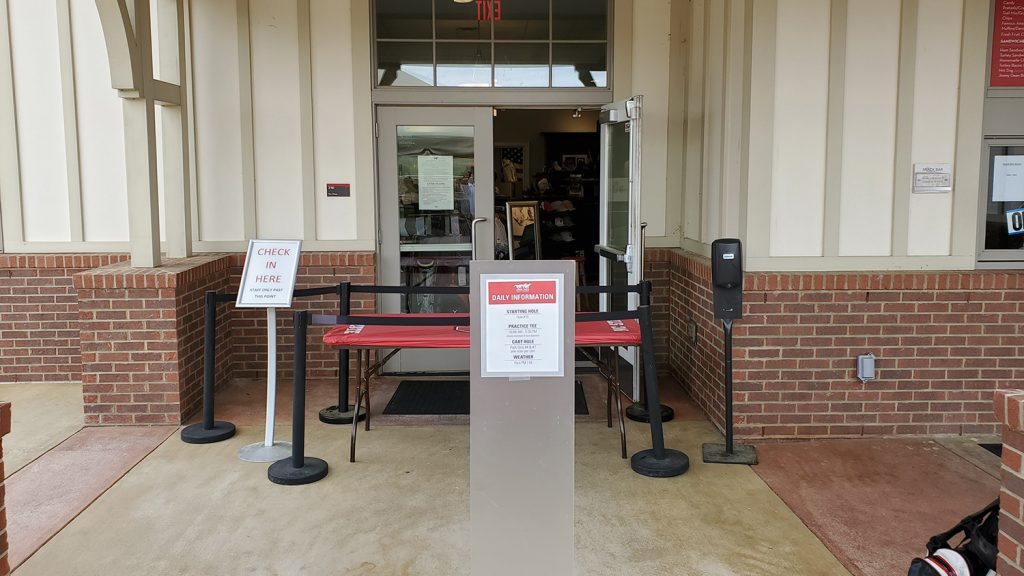 Front of clubhouse with safety notices.