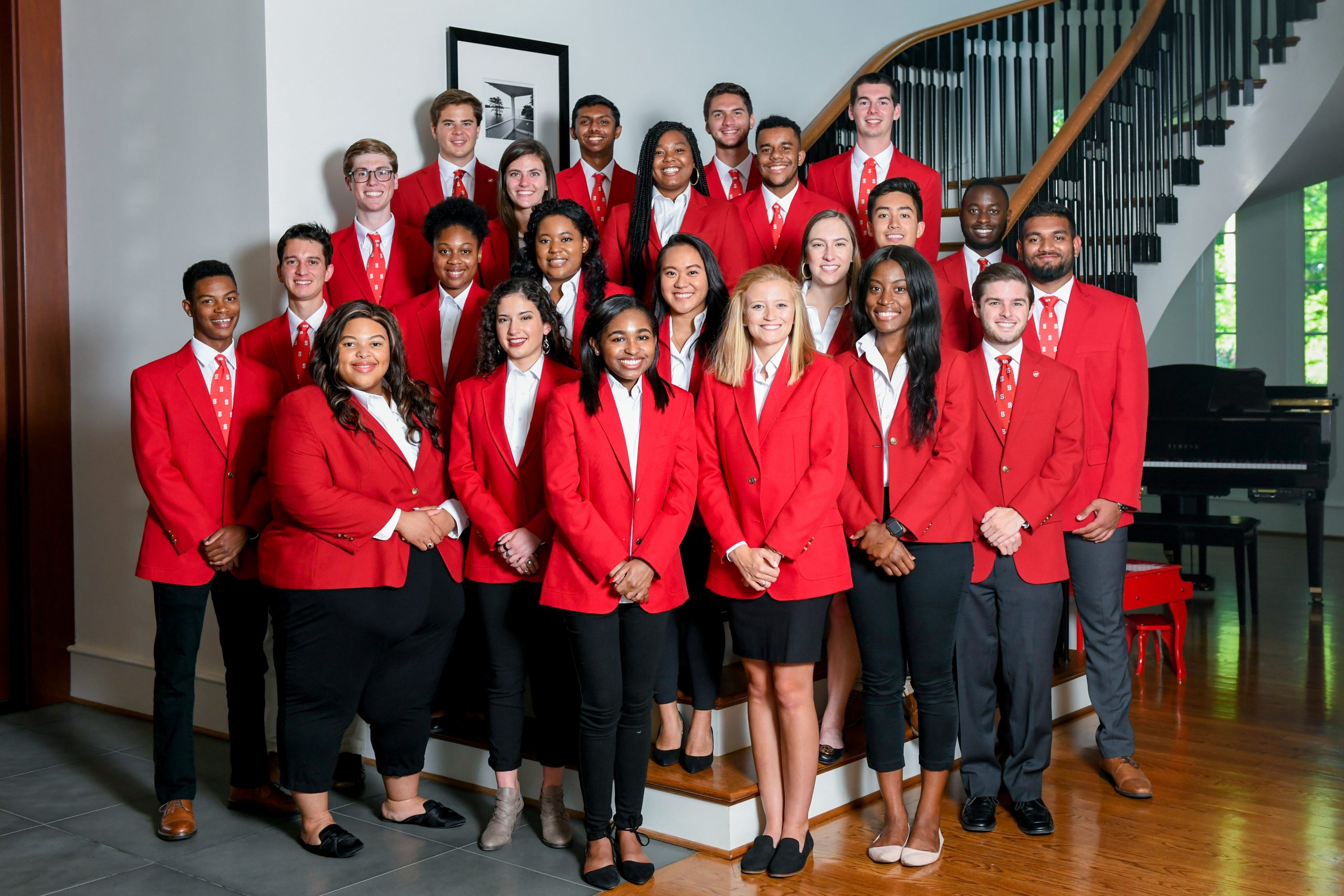 The 2019-2020 Chancellor's Aides take a group photo on a staircase.