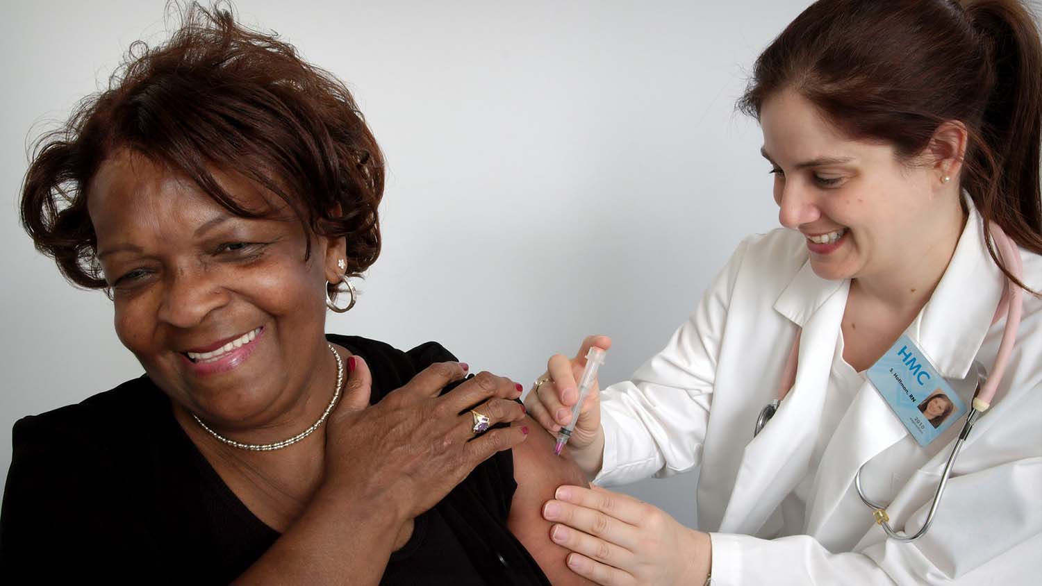 woman receives vaccine shot