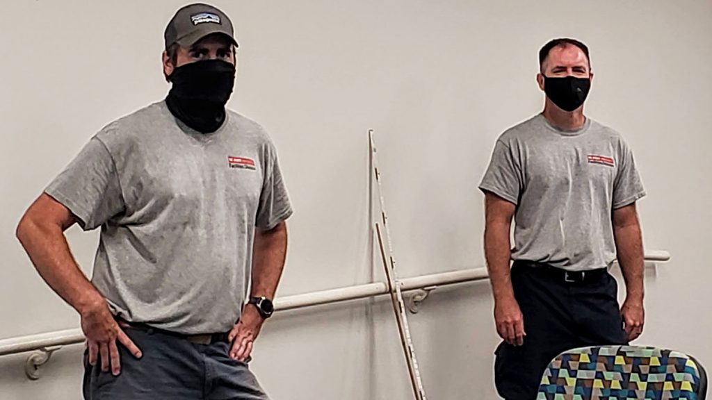 two facilities employees wearing masks