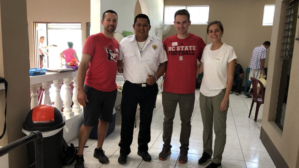 The OpenGait team stands with an above-the-knee amputee in a Guatemalan workshop.