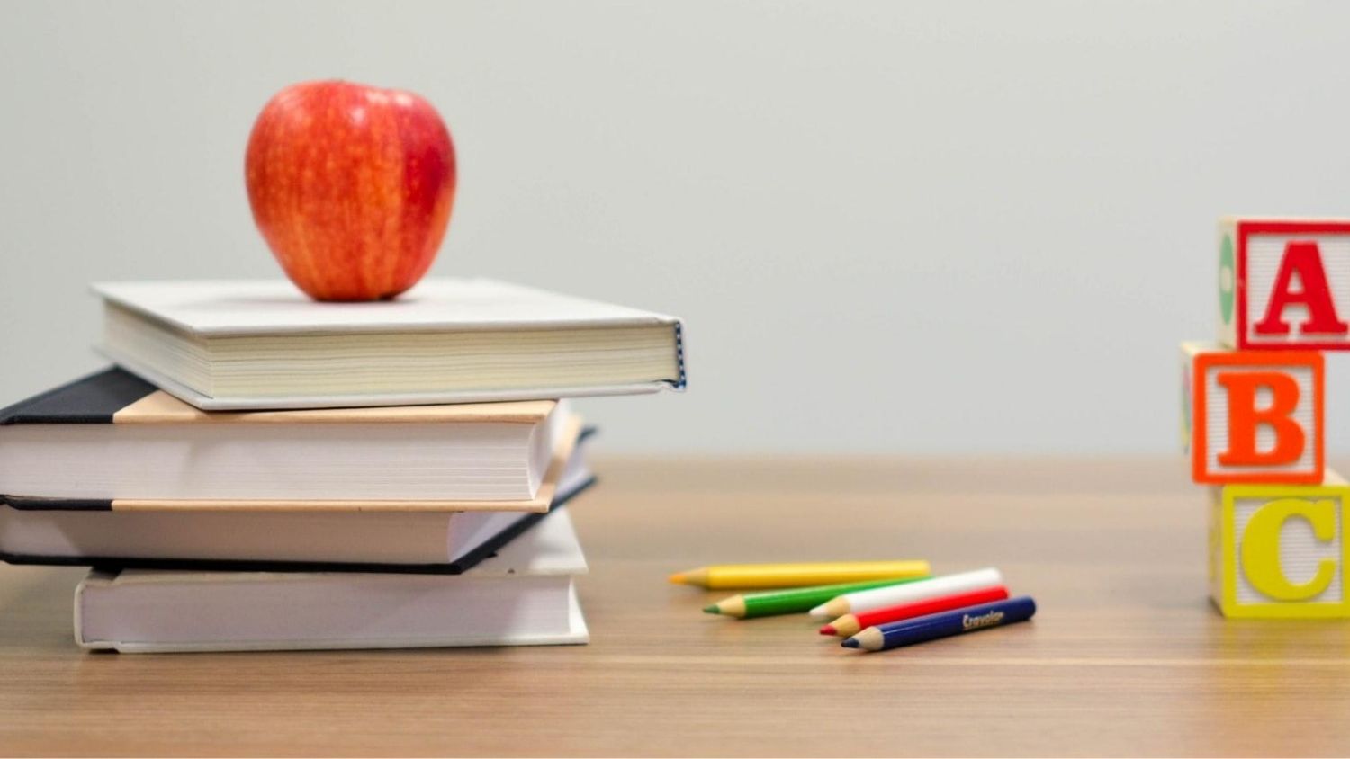 Apple on books in classroom.