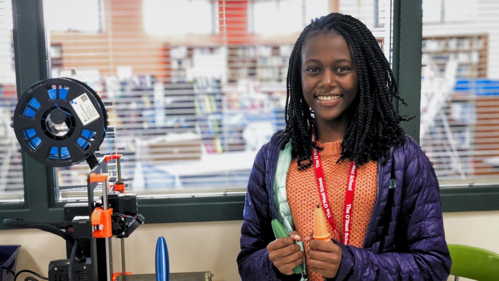 Niasha Kodzai holds pen barrels at her alma mater, the O'Neal School.