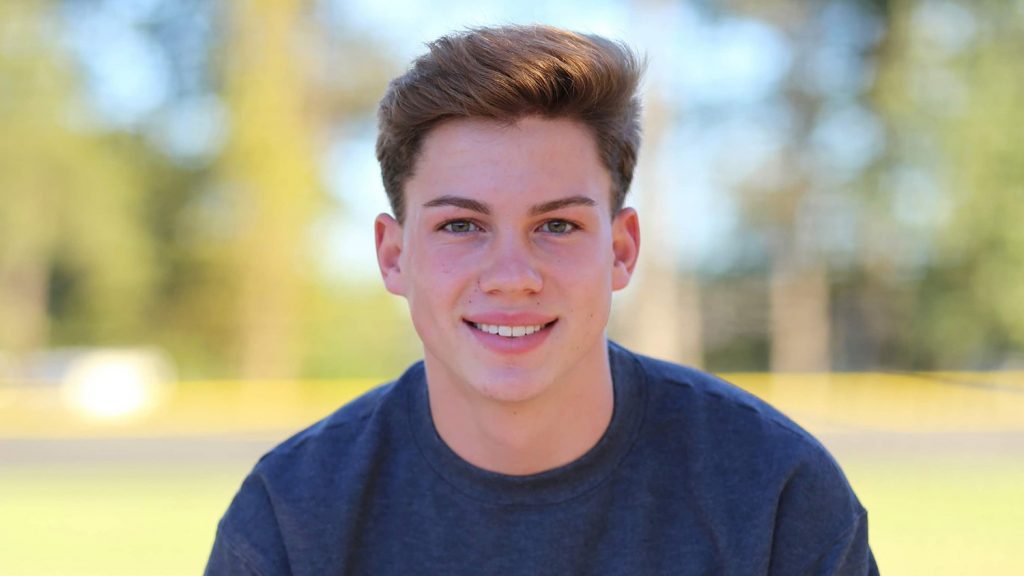 Tripp Johnson poses for a portrait outside.