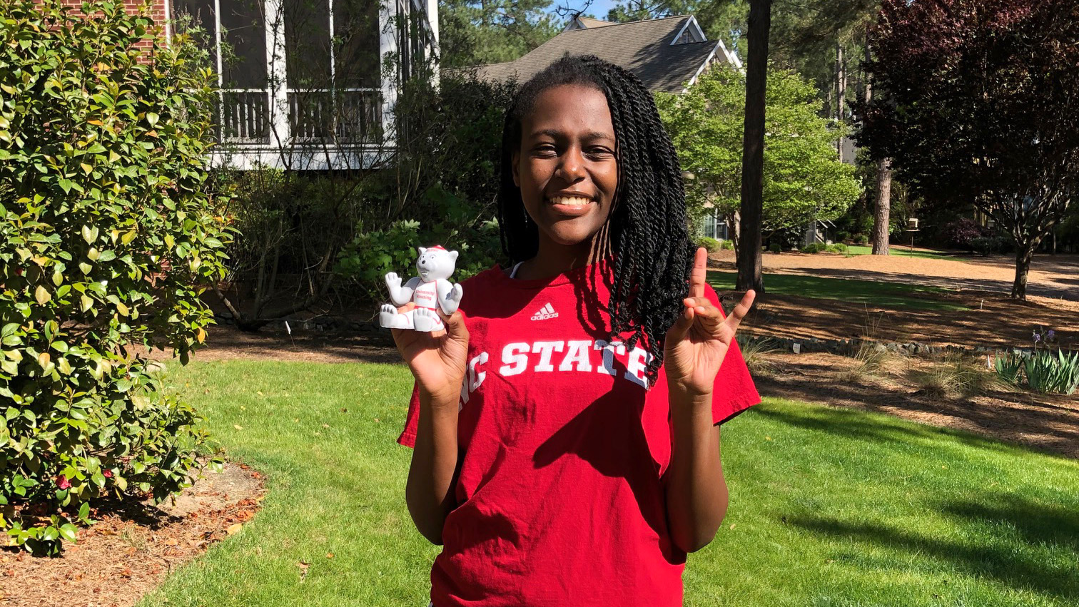 Niasha Kodzai poses outside wearing an NC State T-shirt.