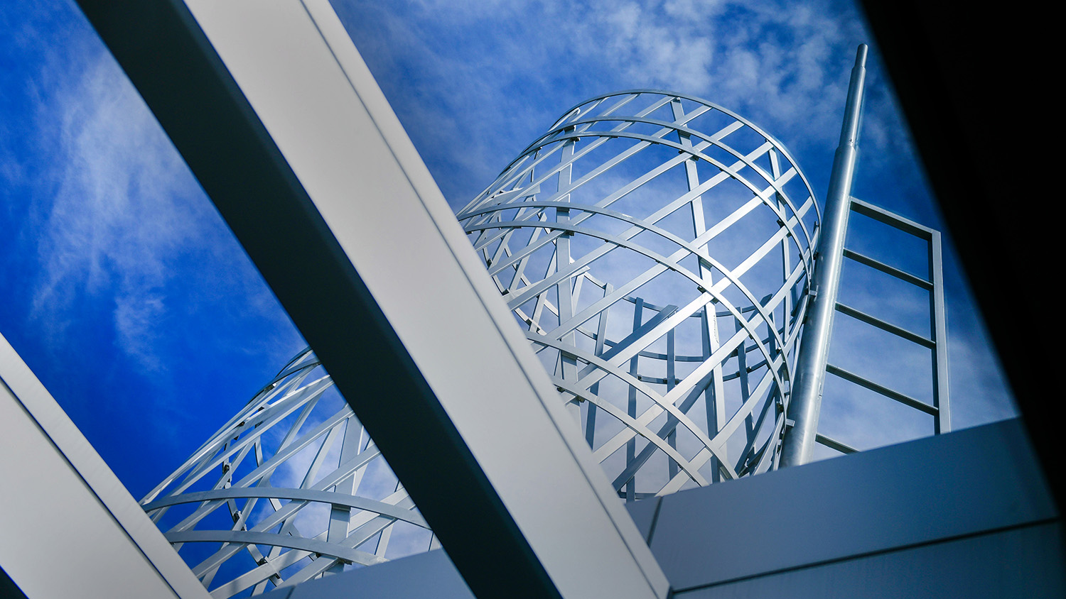 Looking up at the tower over Talley Student Union with a blue sky in the background.