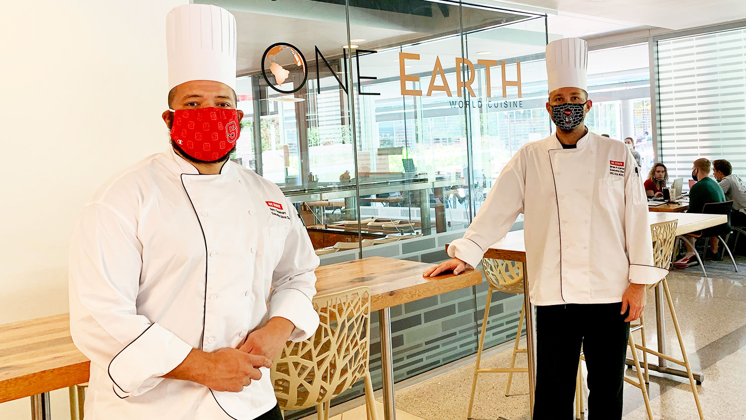 two chefs standing in front of One Earth restaurant