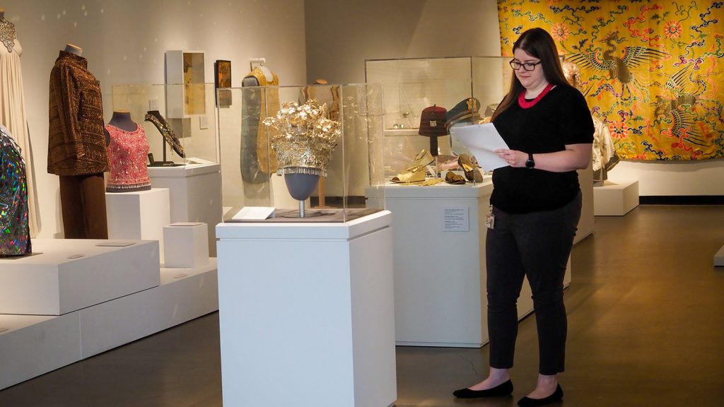 Assistant Registrar Jordan Cao examines a list of items in the Gregg Museum's collection.