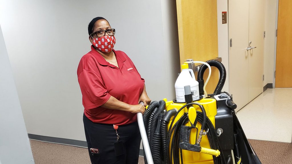 housekeeper with cleaning supplies and equipment