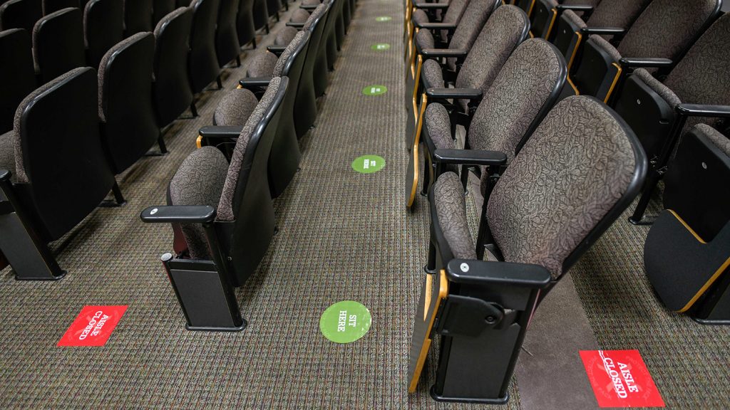 Green and red directional signs have been added to classroom buildings to help students find socially distant seating.