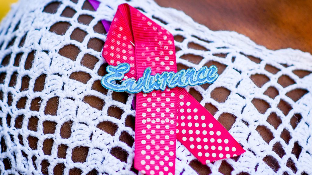 breast cancer ribbon pin with the word "endurance"