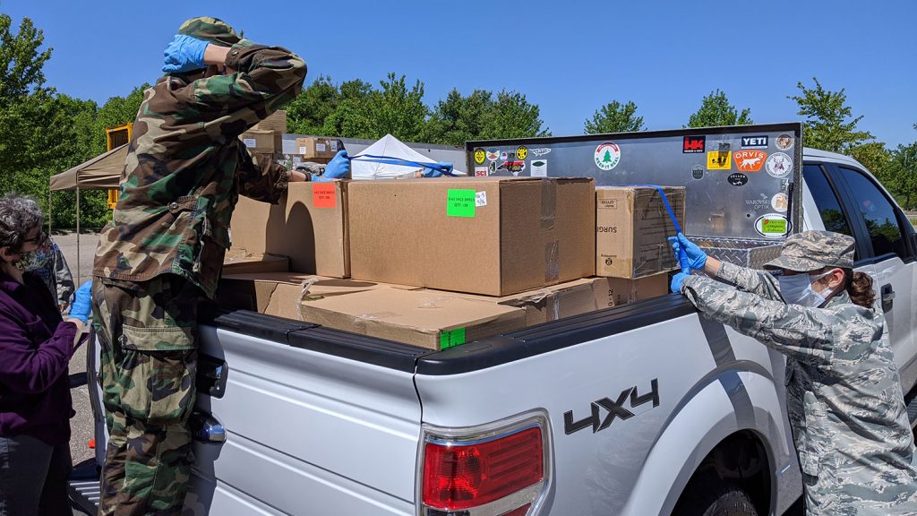 people loading a truck with boxes