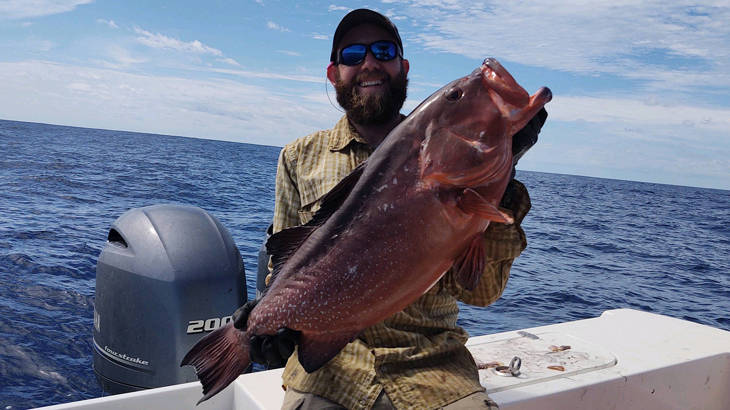 researcher holding a red grouper