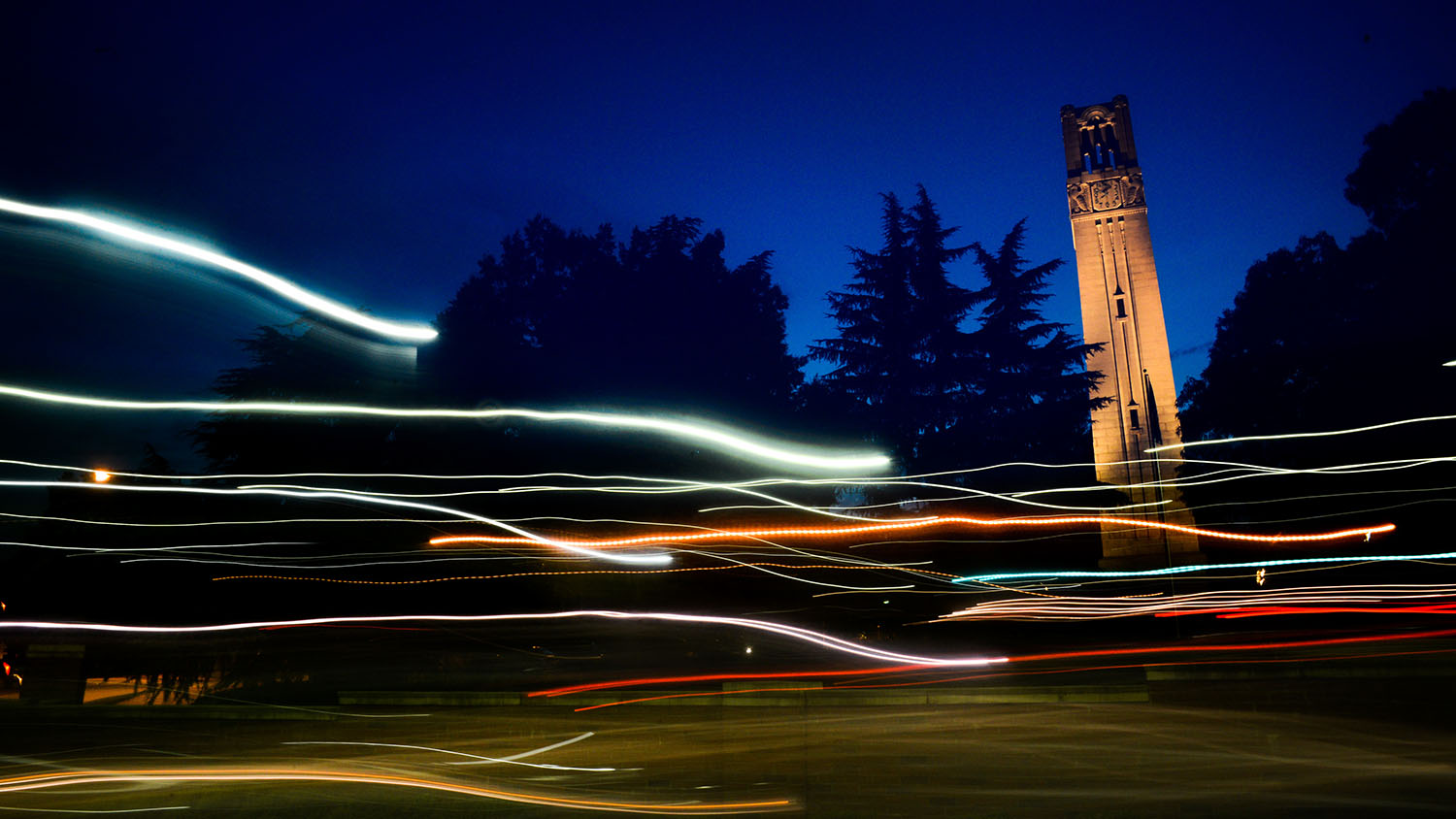 The NC State Belltower at dusk and night. Photo by Marc Hall