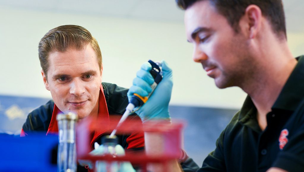 Dr. Rodolphe Barrangou works with another researcher in his lab in Schaub Hall. 