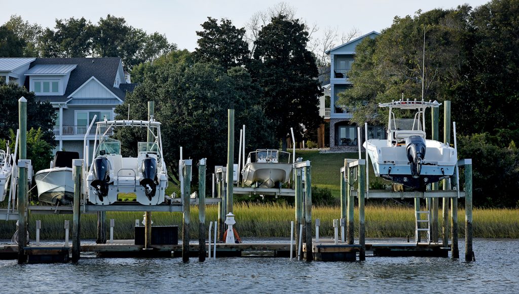 Boats on lifts and homes along Middle Sound near Wilmington.