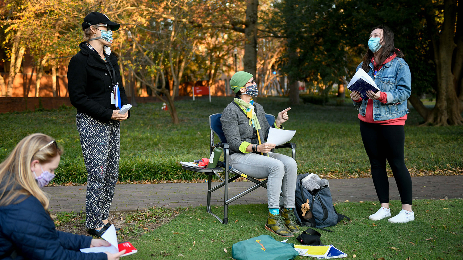 Valerie Faulkner talks with students at a socially distanced outdoor journal exchange