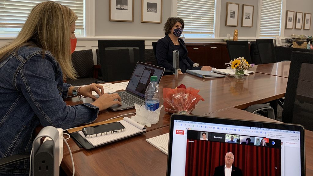 Sheri Schwab in front of her laptop, connecting to the summit remotely.