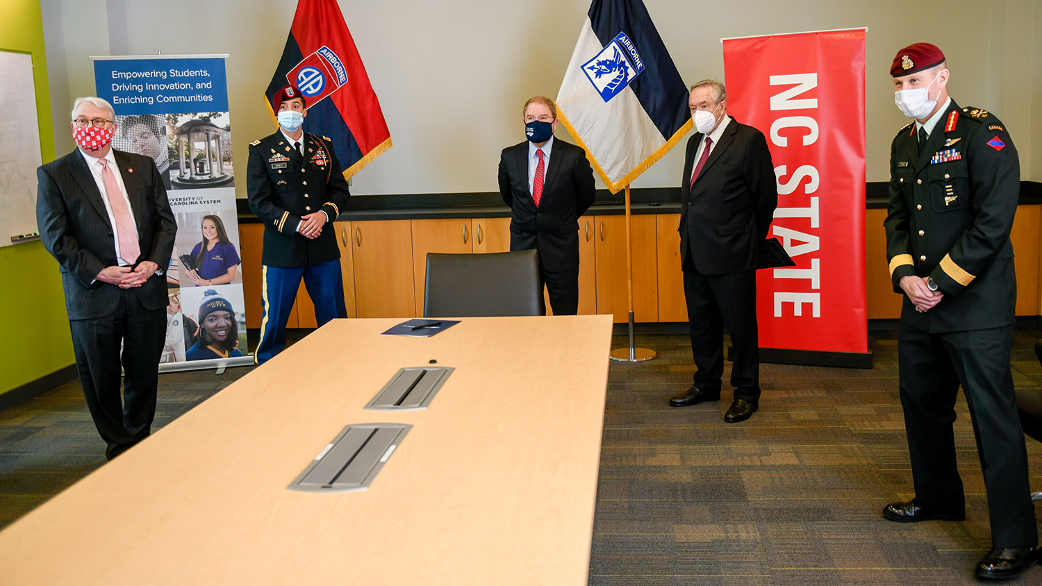 Brig. Gen. Bob Ritchie, UNC System President Peter Hans, NC State University Chancellor Randy Woodson, Vice Chancellor Mladen Vouk and Capt. Dave Giralt attend a signing event to formalize an educational partnership agreement. 