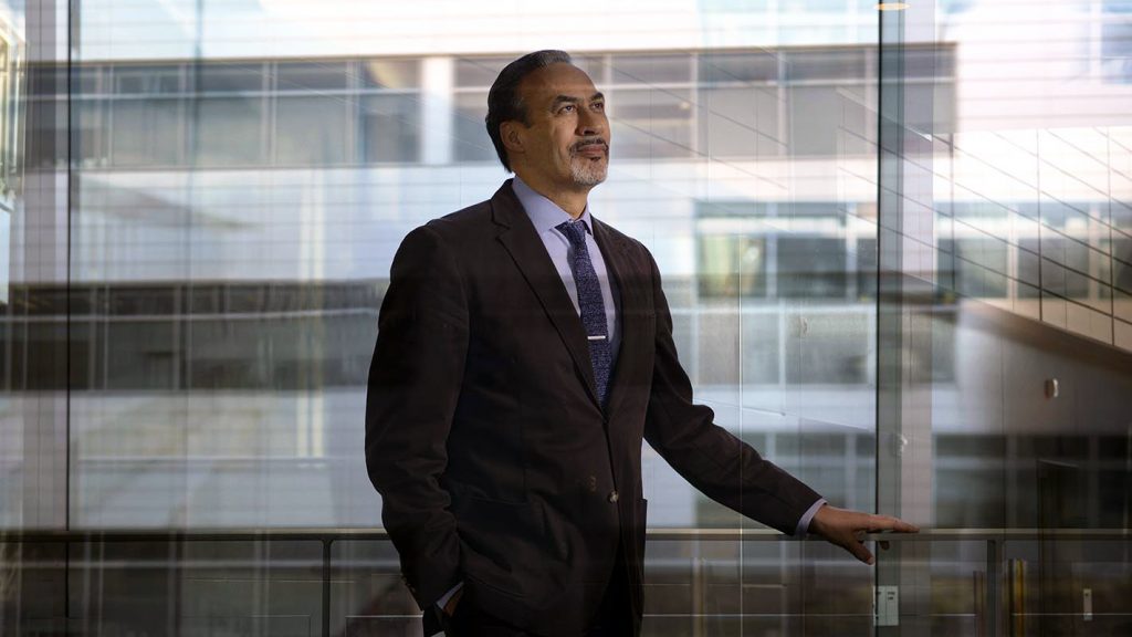 A photo of Phil Freelon in front of a glass building