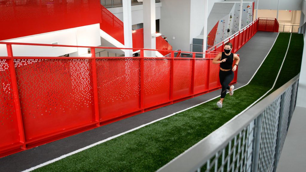 runner on turf sprint ramp at NC State's Wellness and Recreation Center