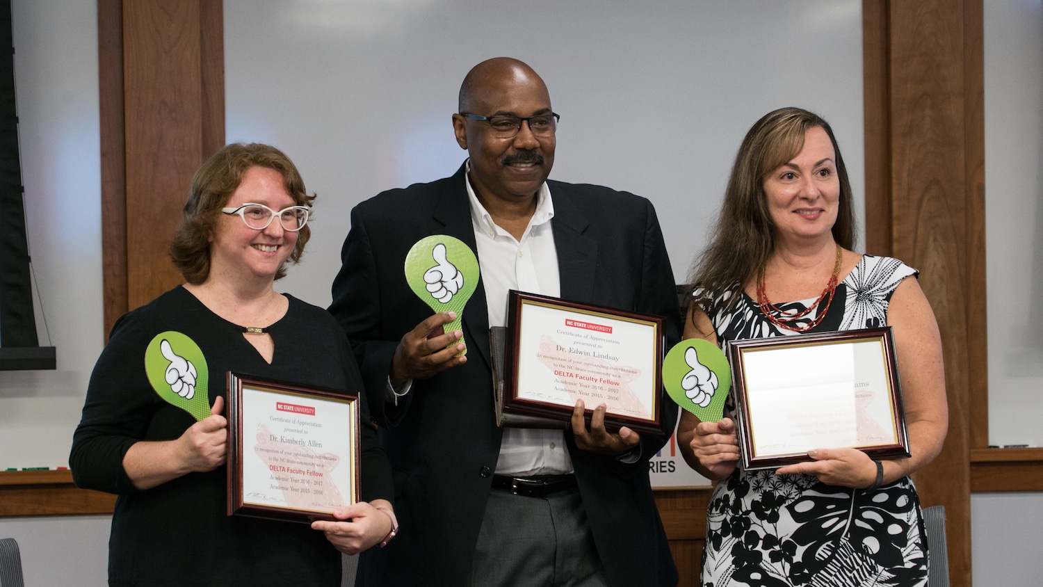 Three faculty members, including Maria Gallardo-Williams (far right) hold their completion certificates from the DELTA Faculty Fellows program.