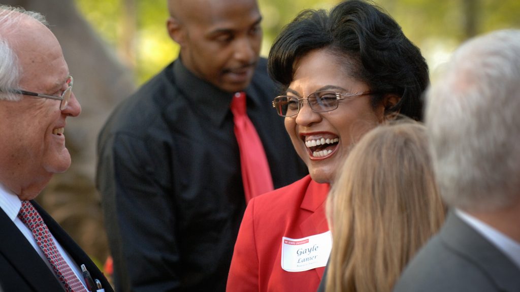 Gayle Lanier laughs with colleagues at a 2013 Board of Trustees dinner.