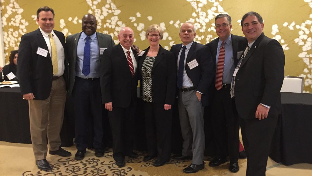 Group of academic leaders connected to NC State pose at an Alumni Association event.